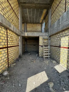 Warm-toned façade harmonizing with the local warm and dry climate.